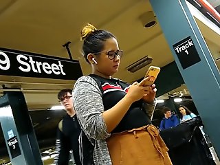 Cute chubby Filipina girl with glasses waiting for train